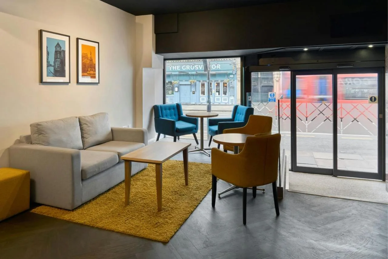 Living area with sofa, chairs and table in a studio at Four Points Flex by Sheraton Edinburgh